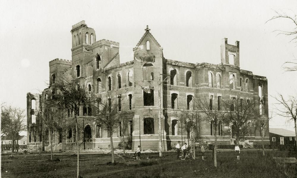 The charred remains of a four-story stone building, TCU's Waco campus main building after a fire